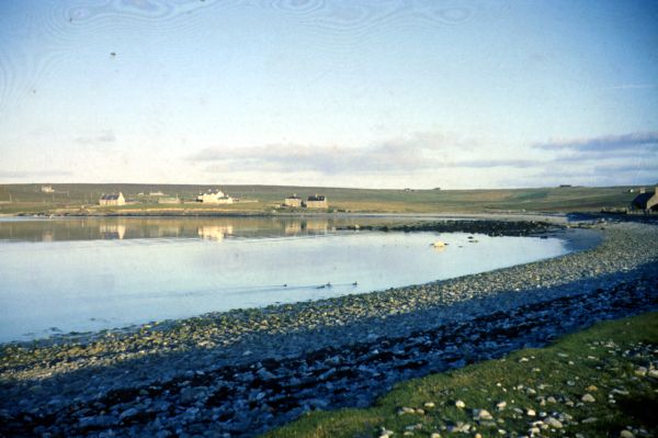 The pebble beach at Baltasound on a calm day